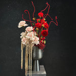 Floral arrangement with red and pink flowers on a black background
