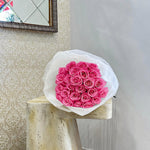 Elegant fuchsia rose bouquet in white wrap by AY Flowers